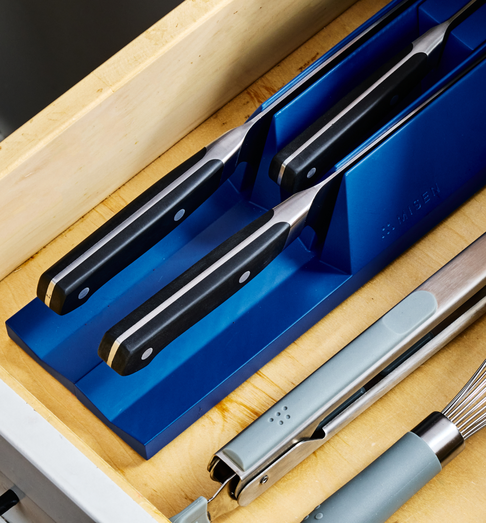 Miden in-drawer knife organizer holding three kitchen knives in blue foam block