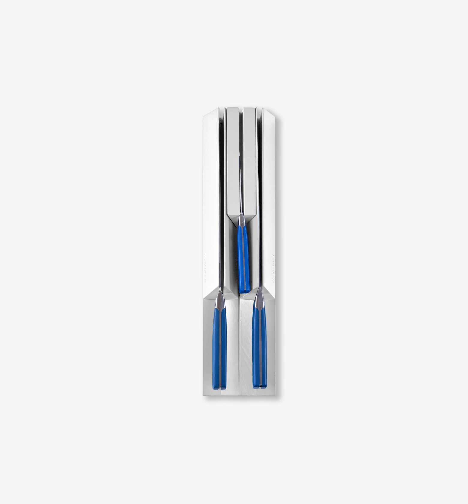 Three-piece knife set with blue handles stored in white magnetic knife block