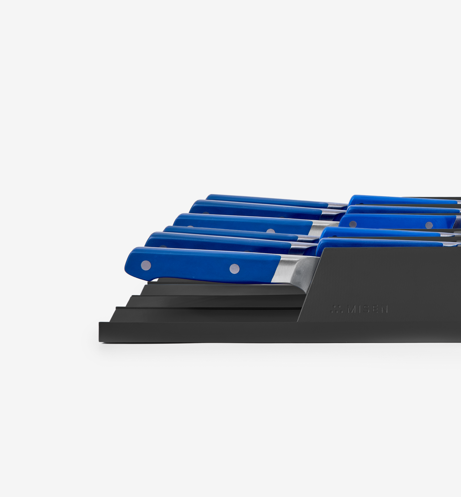 Misen steak knife set with blue handles in black drawer organizer tray