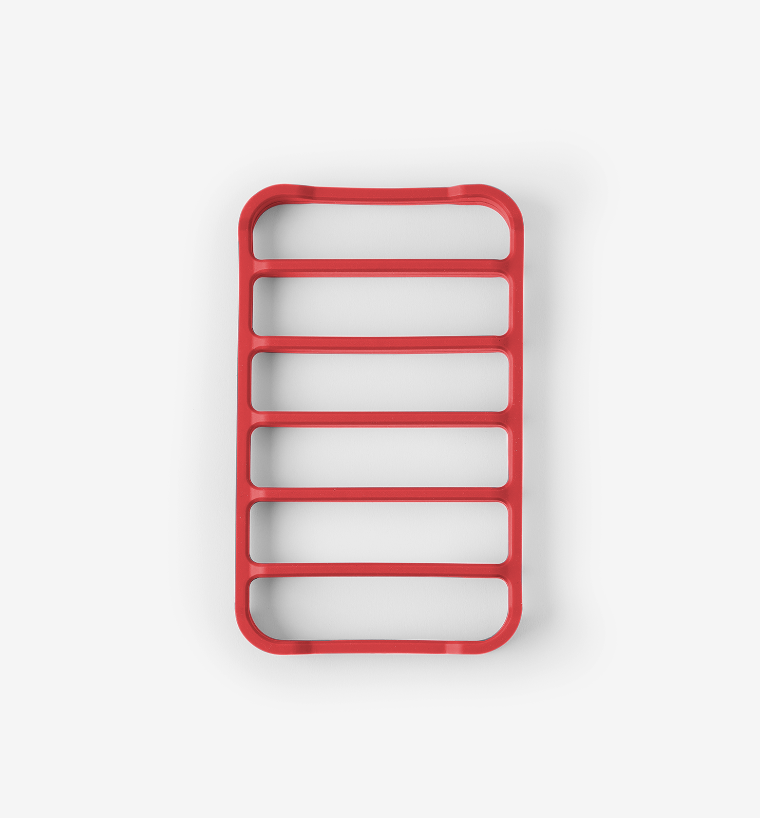 Red silicone trivet with six horizontal slots for heat protection
